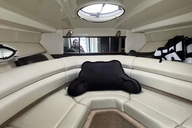 Slide: The Image of Interior of 2016 Monterey 275 Sport Yacht with plush seating and porthole window. - 9