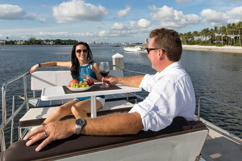 Slide: The Image of Couple enjoying wine and fruit on a 2026 Ranger Tugs R-29 CB boat deck. - 10