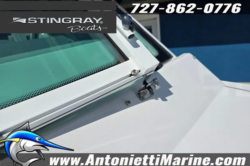 Slide: The Image of 2026 Stingray 259DC boat windshield detail with contact information and logo. - 36