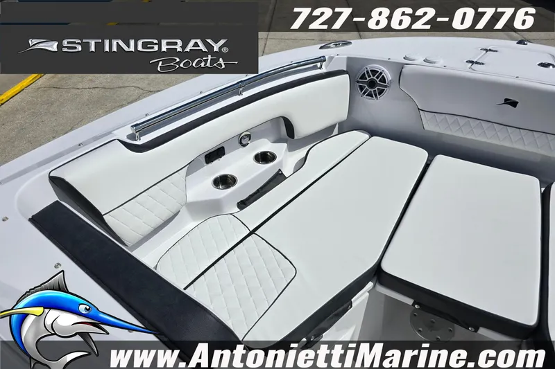Slide: The Image of 2026 Stingray 259DC boat interior with white seating, cup holders, and speaker. - 38