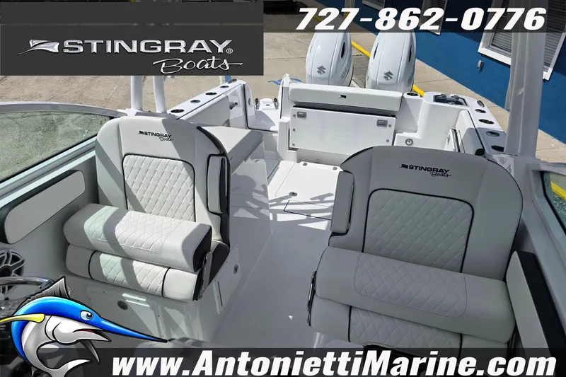Slide: The Image of 2026 Stingray 259DC boat interior with seating, logo, and contact information. - 55