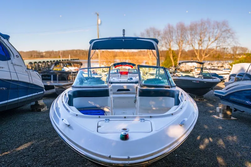 Slide: The Image of 2018 Chaparral 210 Suncoast boat docked outdoors on a sunny day. - 2