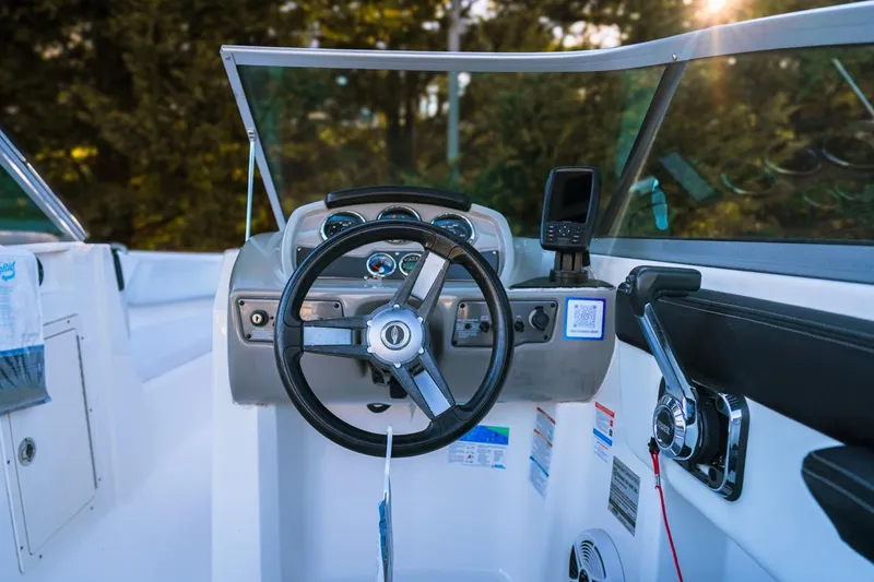 Slide: The Image of 2018 Chaparral 210 Suncoast boat dashboard with steering wheel and controls. - 8
