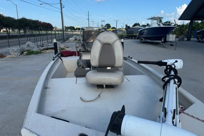 Slide: The Image of 2010 Xpress XP18 boat interior with camouflage seating, parked outdoors. - 10