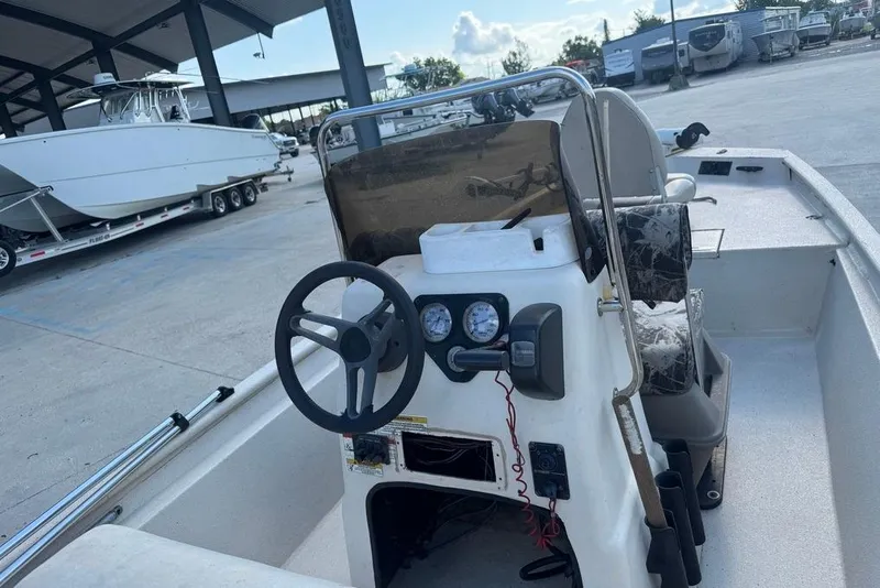 Slide: The Image of 2010 Xpress XP18 boat interior at a marina with surrounding boats and trailers. - 13