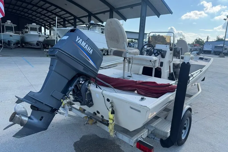 Slide: The Image of 2010 Xpress XP18 boat with Yamaha outboard motor on trailer in marina setting. - 3