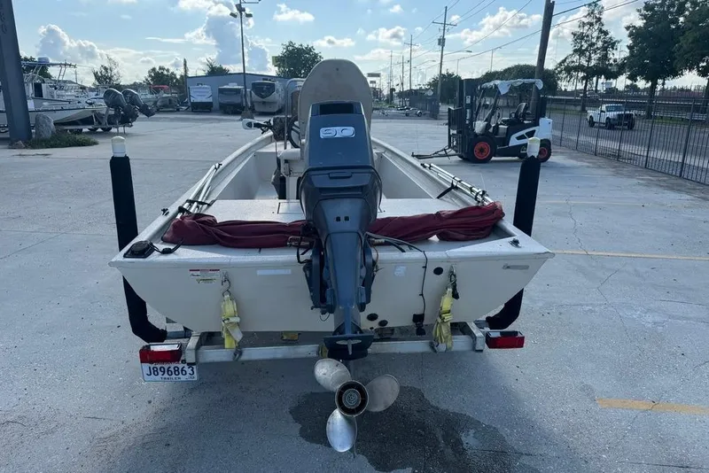Slide: The Image of 2010 Xpress XP18 boat with outboard motor on trailer in parking lot. - 4