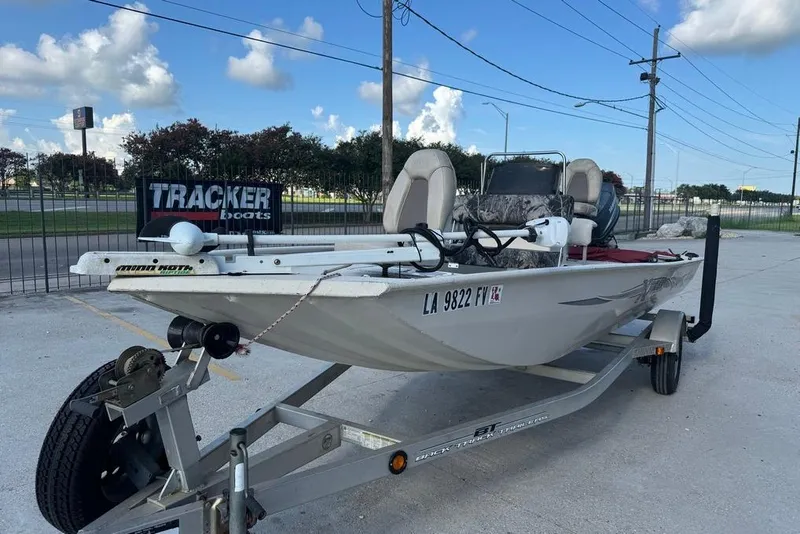Slide: The Image of 2010 Xpress XP18 boat on trailer, parked outdoors, with clear sky background. - 7