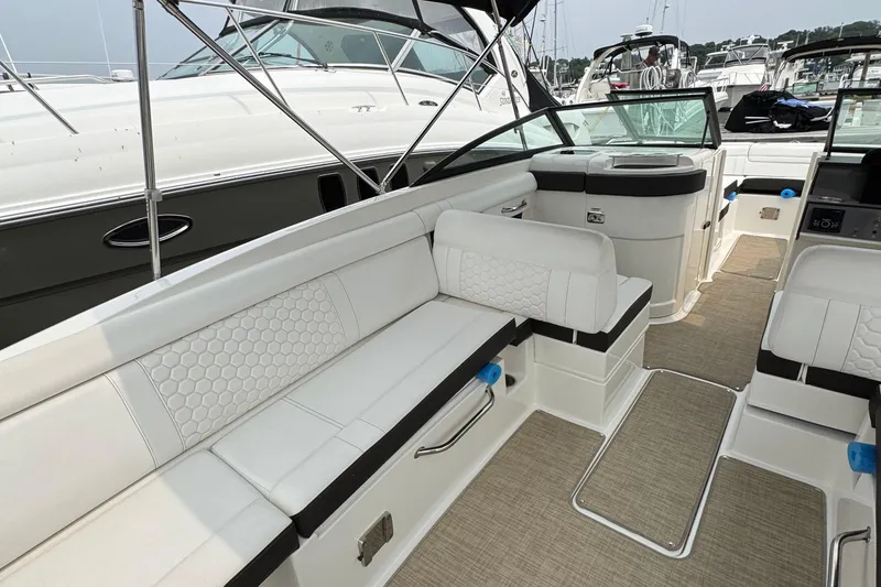 Slide: The Image of 2018 Sea Ray SDX 270 Outboard interior with white seating and modern design. - 13