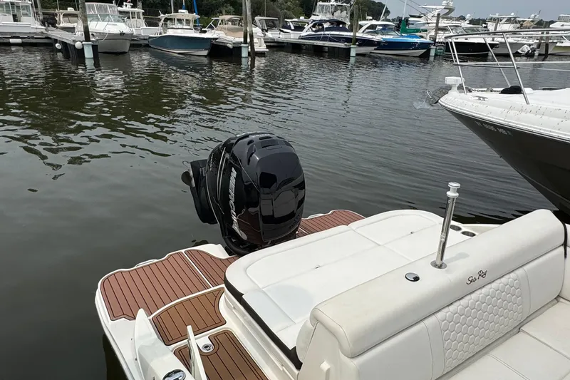 Slide: The Image of 2018 Sea Ray SDX 270 Outboard at marina, featuring sleek design and powerful engine. - 7