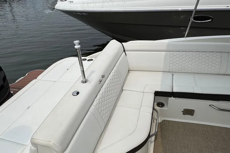 Slide: The Image of 2018 Sea Ray SDX 270 Outboard boat with white cushioned seating and elegant design. - 9