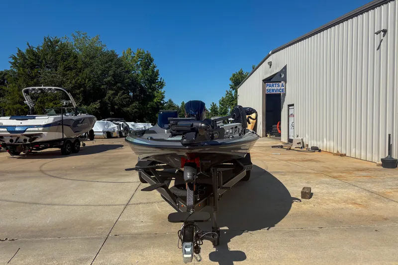 Slide: The Image of 2026 Skeeter ZXR 19 boat parked outside service center on sunny day. - 10