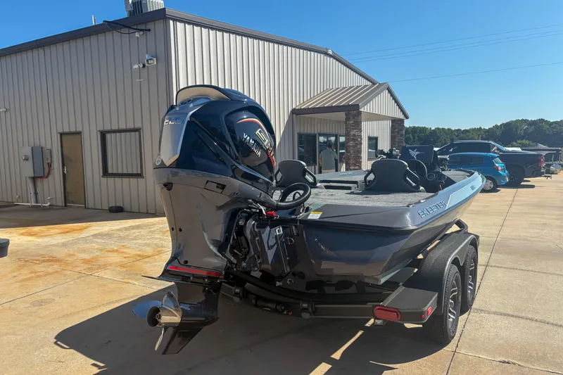 Slide: The Image of 2026 Skeeter ZXR 19 boat with Yamaha engine parked outside a building. - 3