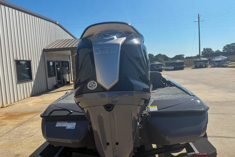 Slide: The Image of 2026 Skeeter ZXR 19 boat with powerful 225 engine, parked outside a building. - 4