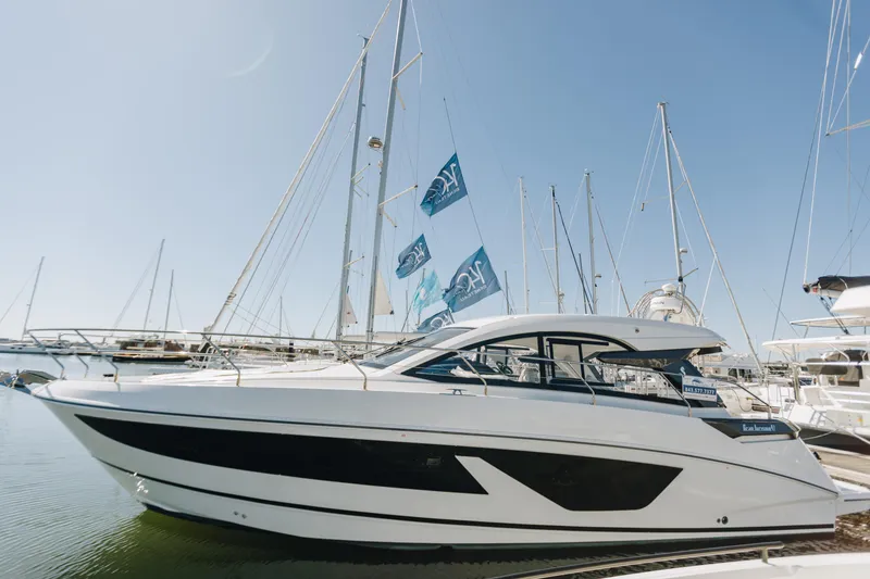 Slide: The Image of 2023 Beneteau Gran Turismo 41 yacht docked at marina under clear blue sky. - 0