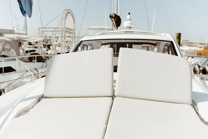 Slide: The Image of 2023 Beneteau Gran Turismo 41 yacht with sunbathing deck in marina. - 1