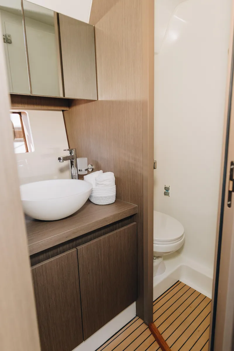 Slide: The Image of 2023 Beneteau Gran Turismo 41 yacht bathroom with modern sink and wooden accents. - 14