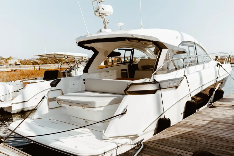 Slide: The Image of 2023 Beneteau Gran Turismo 41 yacht docked at marina, rear view. - 2