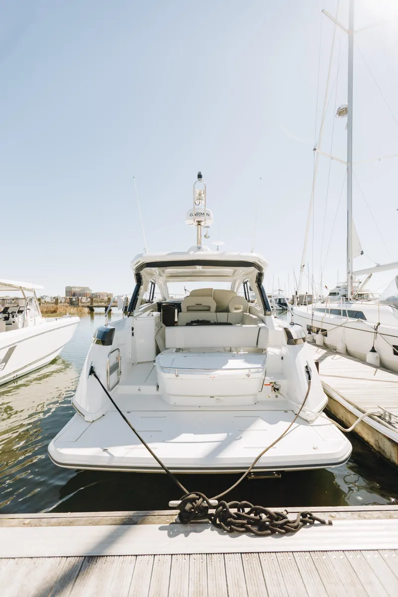 Slide: The Image of 2023 Beneteau Gran Turismo 41 yacht docked at marina, rear view. - 3