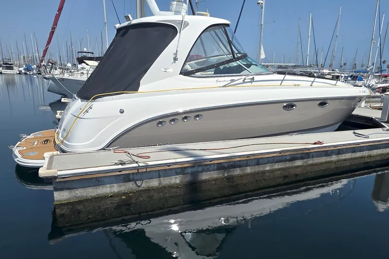 The Image of 2007 Chaparral Signature 350 yacht docked in a marina, reflecting on calm water. - 0