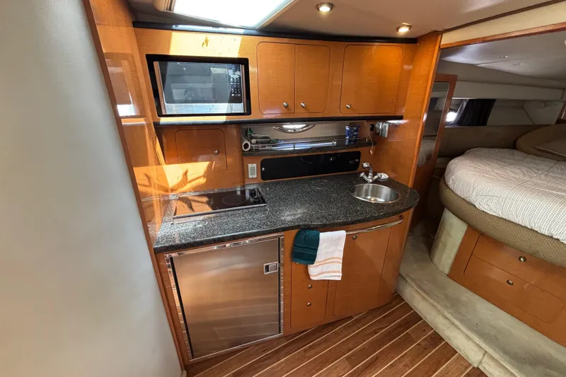 Slide: The Image of 2007 Chaparral Signature 350 yacht interior with kitchenette and cozy sleeping area. - 6