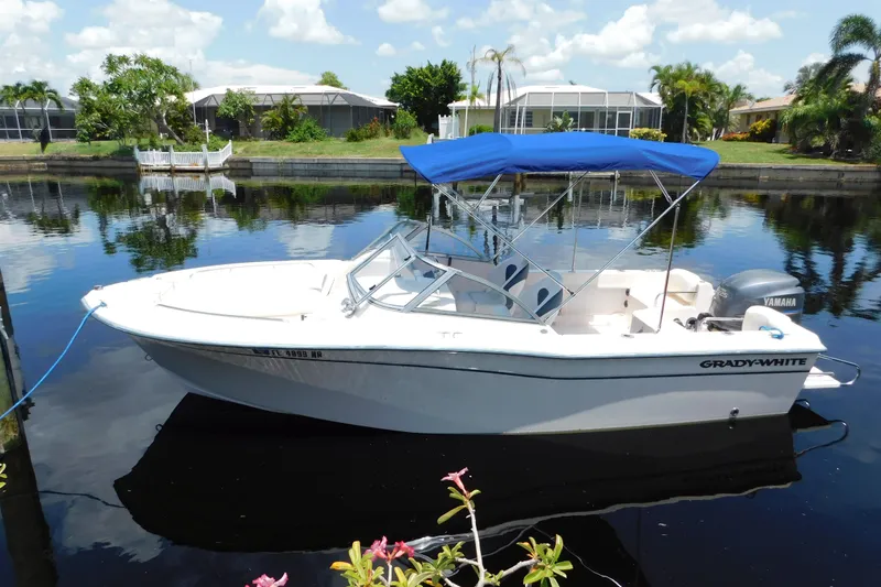 Slide: The Image of 2008 Grady-White Tournament 205 boat with blue canopy on calm water. - 1