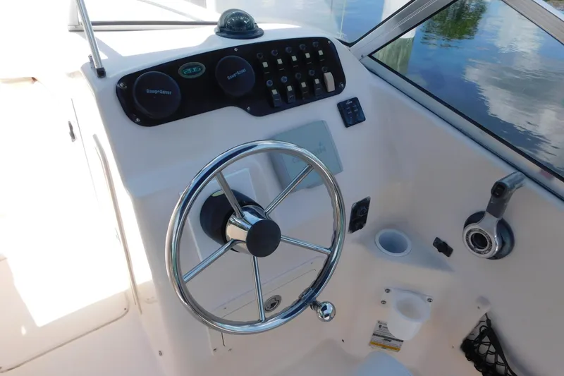 Slide: The Image of 2008 Grady-White Tournament 205 boat helm with steering wheel and control panel. - 10