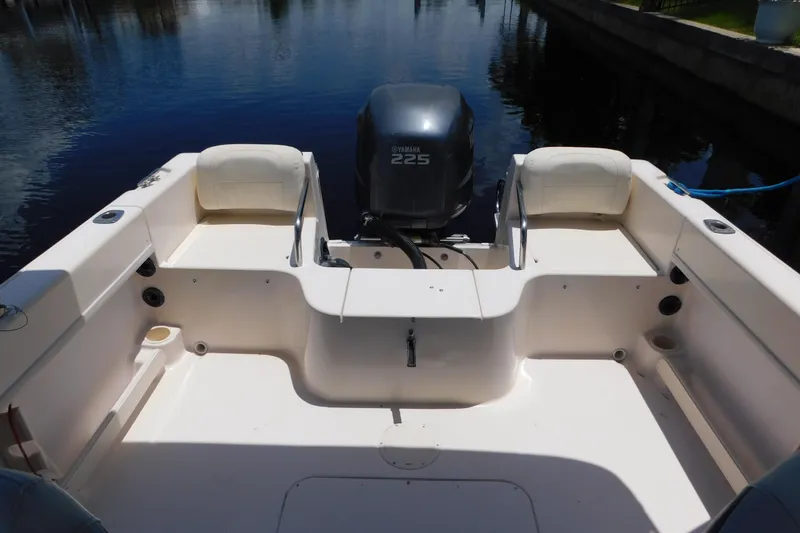 Slide: The Image of 2008 Grady-White Tournament 205 boat interior with Yamaha 225 engine, docked by water. - 15