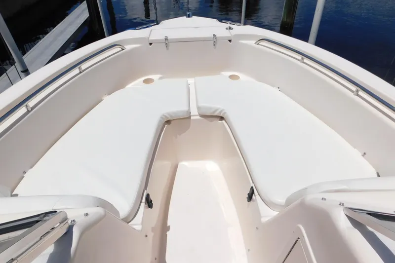 Slide: The Image of 2008 Grady-White Tournament 205 boat interior with white cushioned seating. - 16