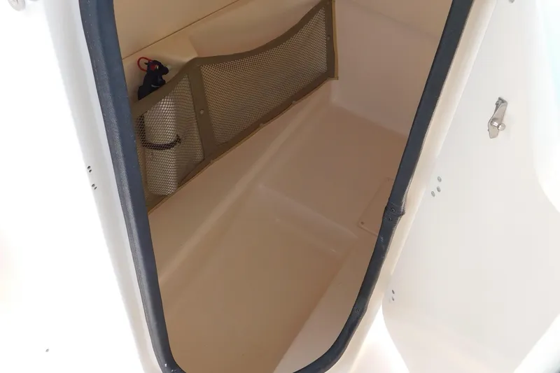 Slide: The Image of 2008 Grady-White Tournament 205 storage compartment with mesh netting and fire extinguisher. - 17