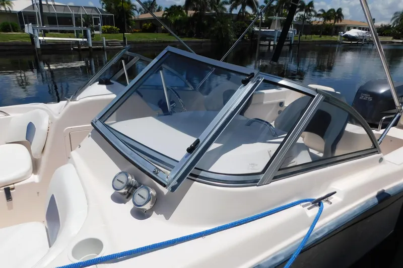 Slide: The Image of 2008 Grady-White Tournament 205 boat docked, featuring windshield and seating area. - 5