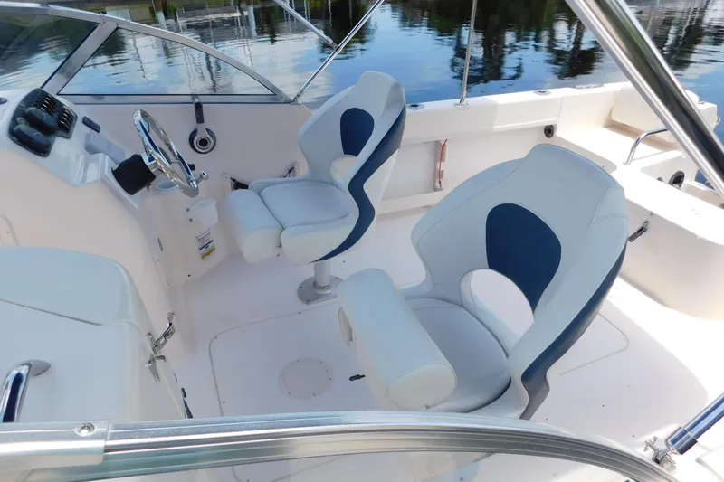Slide: The Image of 2008 Grady-White Tournament 205 boat interior with dual swivel seats and steering wheel. - 8