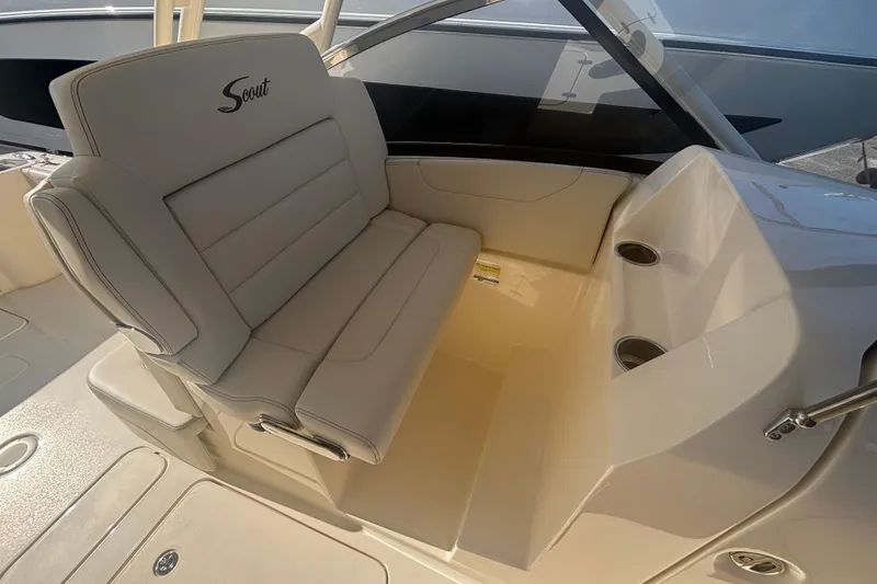 Slide: The Image of 2026 Scout 255 Dorado boat interior with beige seating and cup holders. - 14
