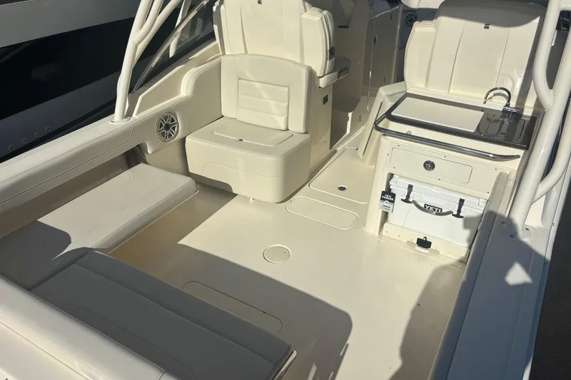Slide: The Image of 2026 Scout 255 Dorado boat interior with seating, sink, and Yeti cooler. - 15