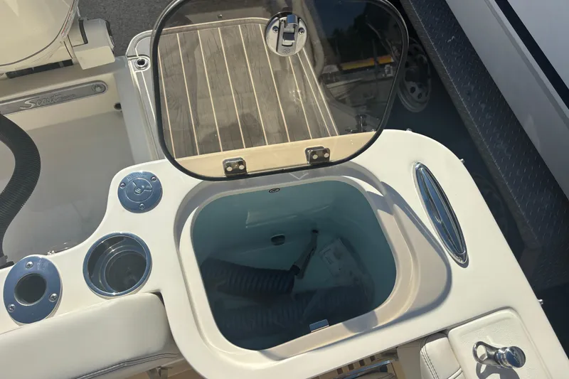 Slide: The Image of Livewell compartment on a 2026 Scout 255 Dorado boat, featuring a clear lid and modern design. - 21
