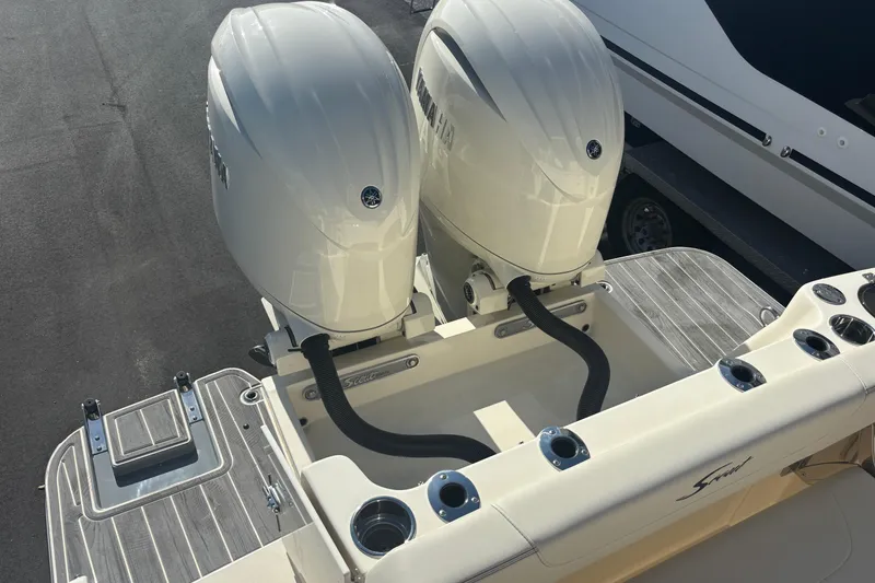 Slide: The Image of 2026 Scout 255 Dorado boat with dual Yamaha outboard engines, docked on a sunny day. - 24