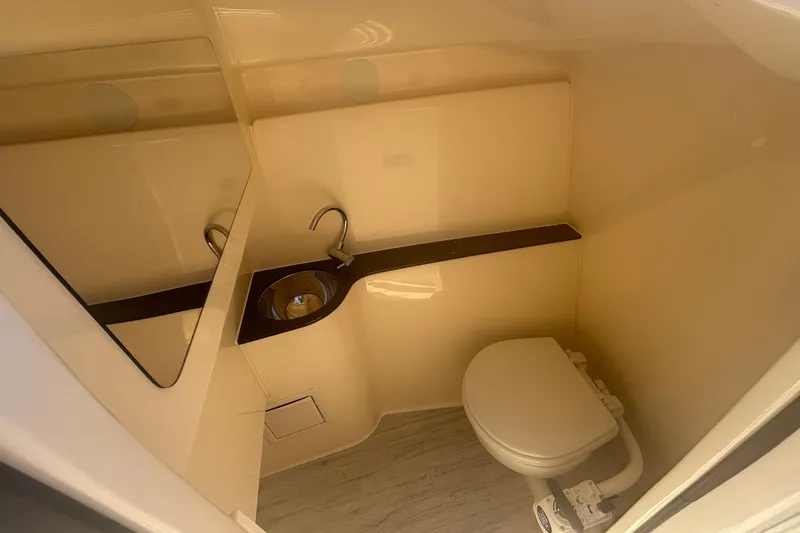 Slide: The Image of 2026 Scout 255 Dorado boat interior bathroom with sink and toilet. - 25