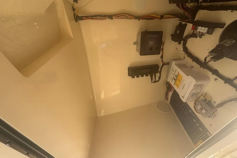 Slide: The Image of Electrical components inside a 2026 Scout 255 Dorado boat compartment. - 26