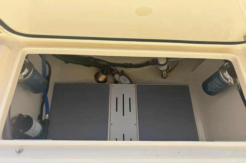 Slide: The Image of 2026 Scout 255 Dorado boat compartment with filters and pumps visible. - 27