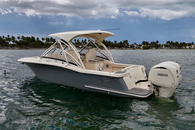 Slide: The Image of 2026 Scout 255 Dorado boat with Yamaha engine on water, palm trees in background. - 3