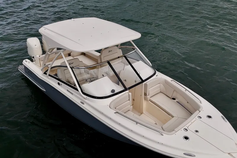 Slide: The Image of 2026 Scout 255 Dorado boat on water, featuring sleek design and spacious seating. - 5