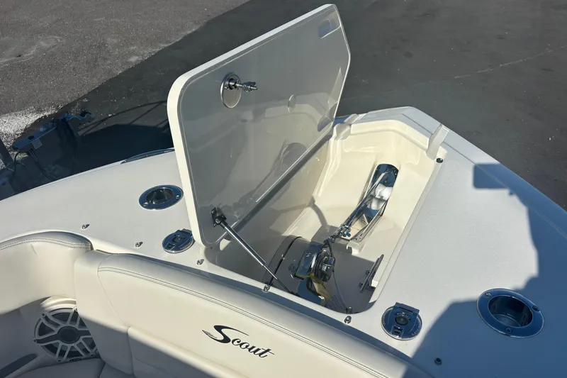 Slide: The Image of 2026 Scout 255 Dorado boat anchor compartment with open hatch, showcasing sleek design. - 9
