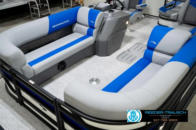 Slide: The Image of 2026 Bennington 21 SSB boat interior with blue and gray seating, Reeder-Trausch Marine logo. - 11