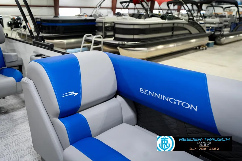 Slide: The Image of 2026 Bennington 21 SSB boat interior with storage compartment, blue and gray seating. - 23