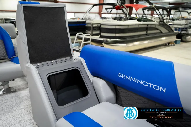 Slide: The Image of 2026 Bennington 21 SSB boat interior with blue and gray seating in showroom. - 24