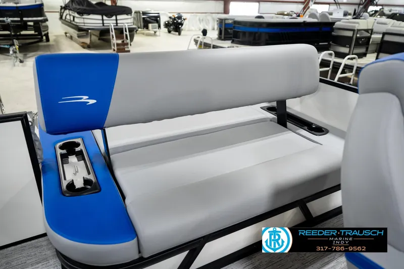 Slide: The Image of 2026 Bennington 21 SSB boat interior with blue and gray seating in showroom. - 25