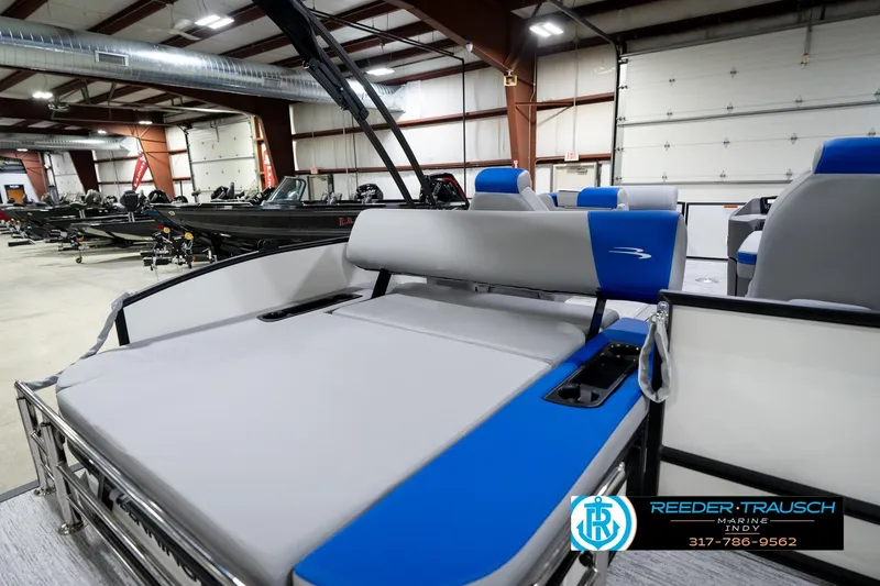 Slide: The Image of 2026 Bennington 21 SSB pontoon boat interior with open storage compartment in showroom. - 27
