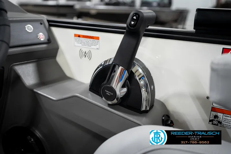 Slide: The Image of 2026 Bennington 21 SSB boat seat with blue and gray design in showroom setting. - 37