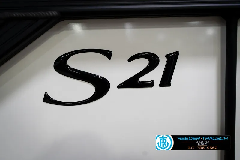 Slide: The Image of 2026 Bennington 21 SSB pontoon boat in showroom, featuring sleek design and modern seating. - 48