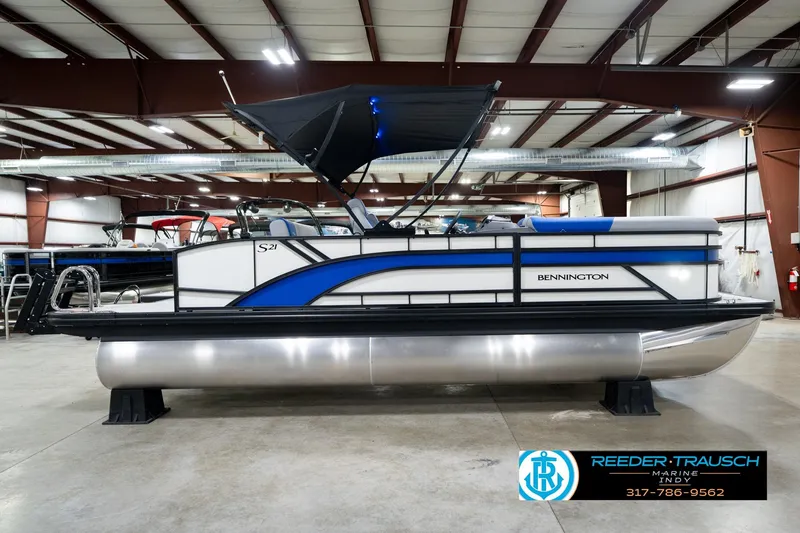 Slide: The Image of 2026 Bennington 21 SSB pontoon boat in showroom with canopy and modern design. - 6